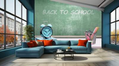 Desk with book and stationery with a chalkboard background Wall mural