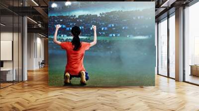 Excited asian football player woman with happy expression Wall mural