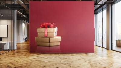 Golden gift box with red ribbon Wall mural