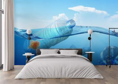 Goldfish trapped on the plastic bottle on the ocean Wall mural