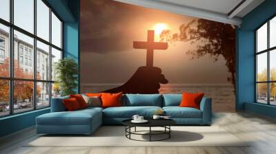 Human hand holding Christian cross Wall mural