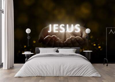 Human hands praying to god with shiny Jesus text Wall mural