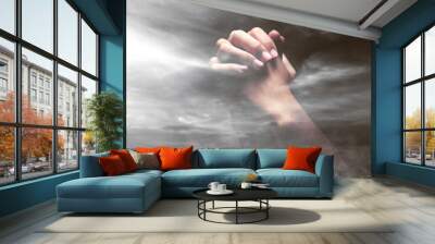 Human hands raised while praying to god Wall mural