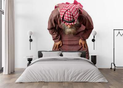 Muslim man with a beard wearing keffiyeh with agal in praying position (salat) on the prayer rug Wall mural