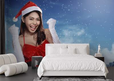 Pretty asian woman in santa claus costume Wall mural