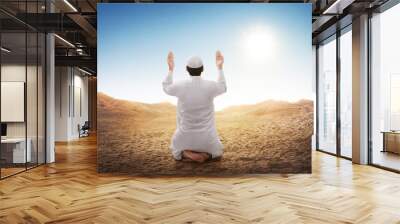 Rear view of asian muslim man sitting and praying Wall mural