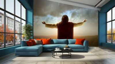 Rear view of Jesus Christ raised hands and praying to god Wall mural