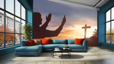 Silhouette man raising hand while praying to jesus Wall mural