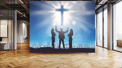 Silhouette of three people looking christian cross on the sky Wall mural