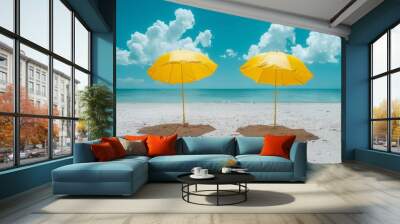 Two Yellow Umbrellas on a White Sandy Beach Under a Bright Blue Sky Creating a Cheerful and Inviting Tropical Scene Wall mural