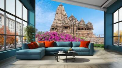 Ancient Indian Khajuraho temple of structure featuring intricate carvings and vibrant floral foreground Wall mural