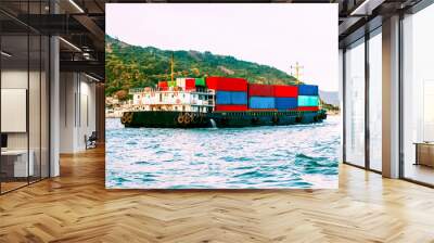 Large cargo nautical vessel in sea harbor before sunset. Business logistic, export, import concept. South China Sea, Pacific Ocean.  Wall mural