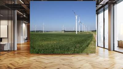 Windmill generator in wide yard / Yard of windmill power generatorunder blue sky, shown as energy industry concept. Wall mural