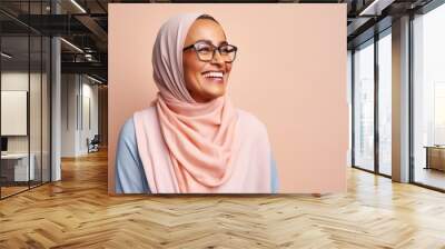 Lifestyle portrait photography of a happy Saudi Arabian woman in her 50s wearing a chic cardigan against a pastel or soft colors background  Wall mural