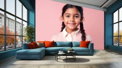 Portrait of a cute little girl in a pink sweater on a pink background Wall mural