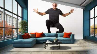 portrait of a Israeli man in his 40s wearing a pair of leggings or tights against a white background Wall mural