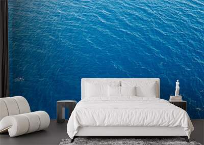 Aerial top down view of sea surface with deep blue water Wall mural