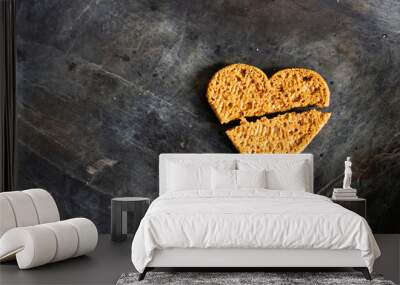 Broken heart cookies on dirty black background.  Wall mural