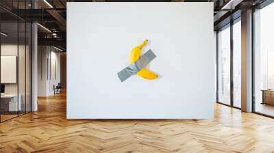 A banana taped to the white wall. Wall mural