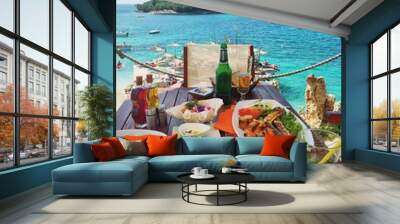 Fresh seafood on the table in summer cafe on the Mediterranean coast. Location famous place Ksamil beach, Saranda popular coastal Albanian resort, Albania, Europa. Beauty world. Mobile photography.
 Wall mural