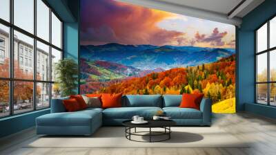 Magical view of the evening mountains with yellow and red trees on the slopes. Wall mural