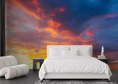 Utterly spectacular sunset with colorful clouds lit by the sun. Bright epic sky. Wall mural