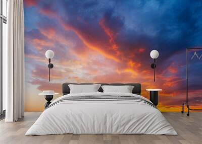 Utterly spectacular sunset with colorful clouds lit by the sun. Bright epic sky. Wall mural