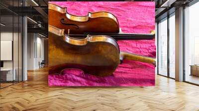 Two violins on a red background. Wall mural