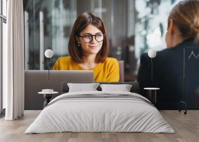 Group of happy business people have meeting at workplace in office. Two positive woman working together using modern laptop for working concept Wall mural