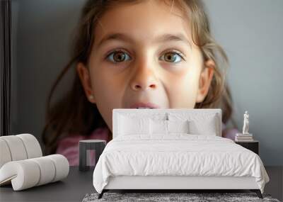 A child girl open her mouth and show her tounge Wall mural