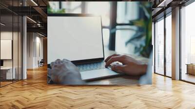 mockup image blank screen computer with blank white background for advertising text,hand man using laptop contact business search information on desk at home office.marketing and creative Wall mural