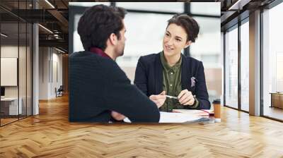 Tell me why you are suited for this position. Cropped shot of a businesswoman conducting an interview with an unidentifiable candidate in her office. Wall mural