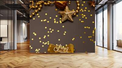 Christmas golden decorations with gift boxes on dark background. Template for greeting card Wall mural