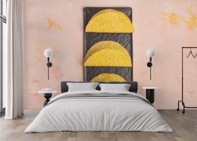 Empty taco shells on board on dark background Wall mural