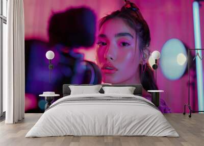 Young Woman in Professional Beauty Setup with Camera and Studio Lights Wall mural