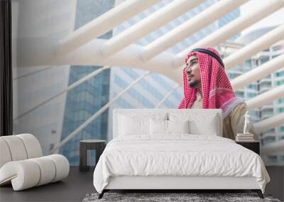 portrait of young arabian businessman holding the briefcase and standing in downtown with commitment Wall mural