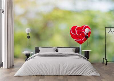 sweet candy shaped red heart for love in garden with bokeh backg Wall mural