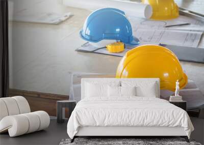 The safety helmet and the blueprint on table at construction site Wall mural