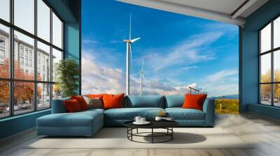 White wind turbine for alternative energy in day with blue sky background, electric clean power concept Wall mural