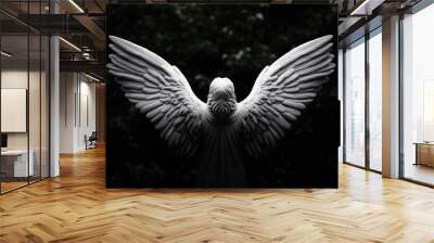 A serene angel sculpture with expansive wings, capturing the essence of peace and protection in a dark, moody backdrop. Wall mural