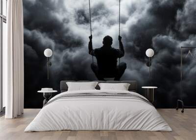 A silhouette of a person on a swing against a dramatic, cloudy sky, capturing a sense of solitude and contemplation. Wall mural