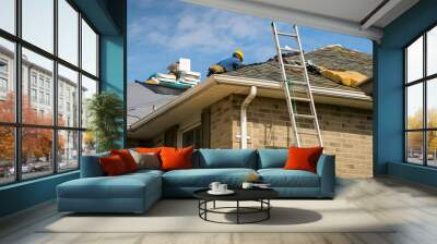 Roof worker installing new shingles on a roof of a house Wall mural