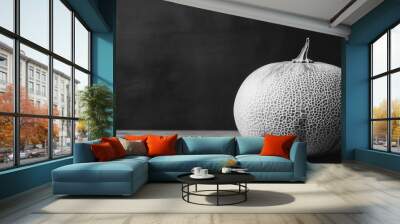 A single cantaloupe melon sits on a wooden table against a dark background. Wall mural