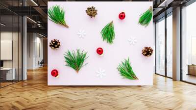 Christmas tree branches, Christmas decorations on a pink background, top view, flat lay. Wall mural