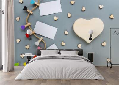 Clothespins in the form of hearts on a gray background. Large wooden heart with copyspace and lots of small hearts Wall mural