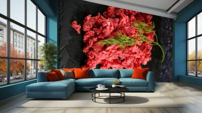 fresh raw ground beef meat heap on black background. Top view Wall mural