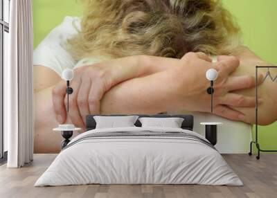 middle aged depressed woman sitting on floor covering head with hands at home or hospital. Lonly , sad, negative emotion and mental health concept. Wall mural