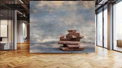 Selective focus Broken chocolate pieces  on wooden background Wall mural