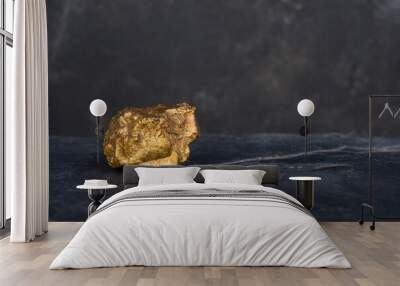 The pure gold ore found in the mine on a stone background.soft focus Wall mural