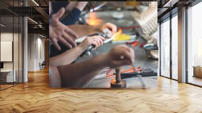 Students at work in a glass-blowing workshop. Glass on fire. Wall mural